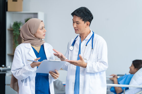 Two conficent doctor or specialist of kidney cancer talking together with female mix race patient on bed at medical ward, checkup, recovering after successful surgery concept.
