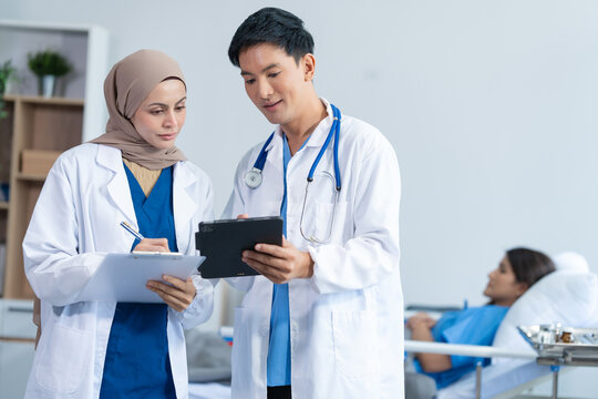 Two conficent doctor or specialist of kidney cancer talking together with female mix race patient on bed at medical ward, checkup, recovering after successful surgery concept.