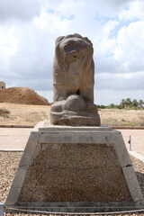 Several perspectives of the Lion of Babylon statue in the ancient city of Babylon on a cloudy day