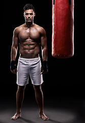 Fototapeta na wymiar Studio, boxer and portrait of man, punching bag and gloves for training with strength and muscle. Adult, athlete and male person in dark background, healthy and power with body, job and sport
