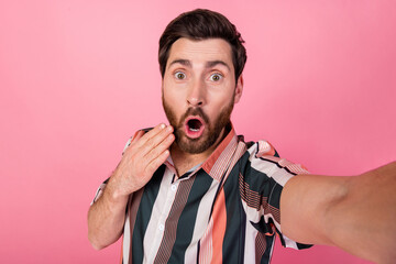 Selfie of funny emotions mature age blogger man in striped t shirt touch cheek speechless...