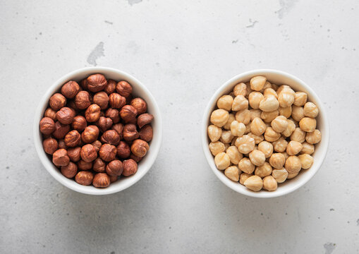 Peeled and blanched healthy hazelnut nuts on light background.Top view.