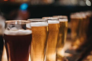 Close up of a rack of different kinds of beers, dark to light.