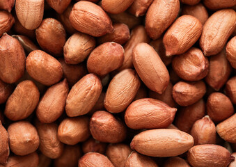 Raw peeled red peanut nuts top view macro background.Top view.