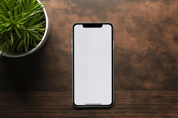 mockup smartphone with empty blank screen on a table, workplace, office, top view