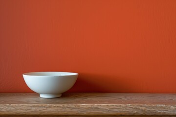 simple and Minimalistic background with bowl in front of  a terracota wall