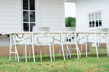 White dining set of furniture, table and chairs on the glass for outdoor living.