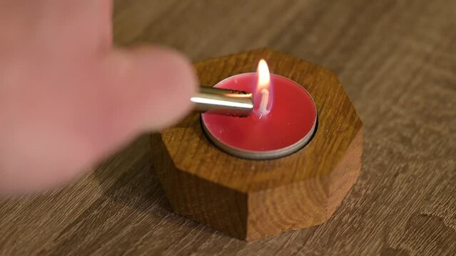 Igniting aroma candle with a lighter. Using aromatic candle for pleasant smell at home, aromatherapy