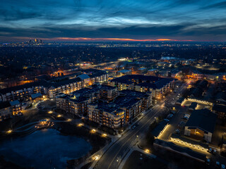 Fototapeta na wymiar Evening aerial view of Saint Anthony Village with Downtown Minneapolis in the background