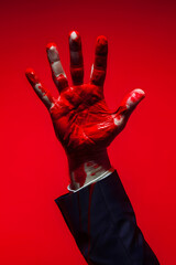 businessman hand with stains of red paint - 763940228
