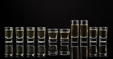 Foto op Plexiglas Strong alcoholic drink shots on a black background. © Igor Normann