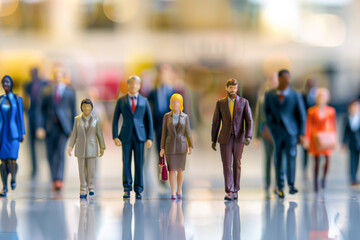 Miniature people : Businessman and businesswoman walking in the office.
