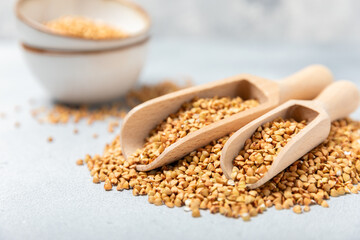 Green buckwheatin  on a wooden kitchen table.Superfood.Raw buckwheat porridge.Healthy vegan food concept, eco products, diet. Copy space.Organic food.weight loss and proper nutrition.