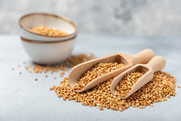 Green buckwheatin  on a wooden kitchen table.Superfood.Raw buckwheat porridge.Healthy vegan food concept, eco products, diet. Copy space.Organic food.weight loss and proper nutrition.