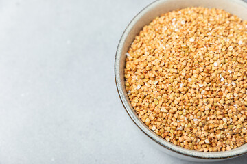 Green buckwheatin  on a wooden kitchen table.Superfood.Raw buckwheat porridge.Healthy vegan food concept, eco products, diet. Copy space.Organic food.weight loss and proper nutrition.