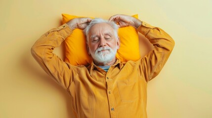 Elderly man sleeping on pillow isolated on pastel yellow colored background Sleep deeply peacefully rest. Top above high angle view photo portrait of satisfied .senior wear yellow shirt