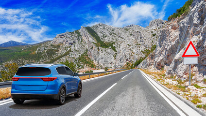 Blue car on asphalt road. Asphalt road view in countryside at beautiful sunset