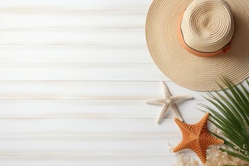 A straw hat with starfish on a white wooden background. copy space. background