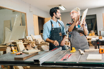 In a carpenter's shop, a skilled man with training in the craft uses tools to perform woodwork, blending occupation, industry, and business.