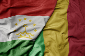 Fototapeta premium big waving national colorful flag of mali and national flag of tajikistan.