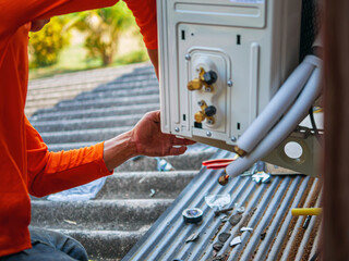 Air conditioning technicians install new compressor air in homes, Repairman fix air conditioning...