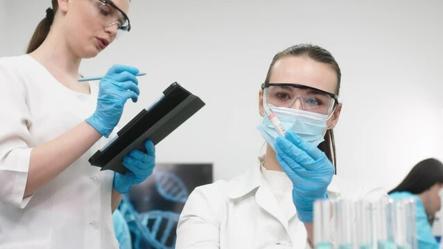 Medical research laboratory. A scientist works with a pipette and a test tube. Scientific laboratory of biotechnology, development of medicine and research in chemistry, biochemistry and experiments