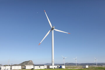 A wind turbine is a device that converts the kinetic energy of wind into electrical energy.