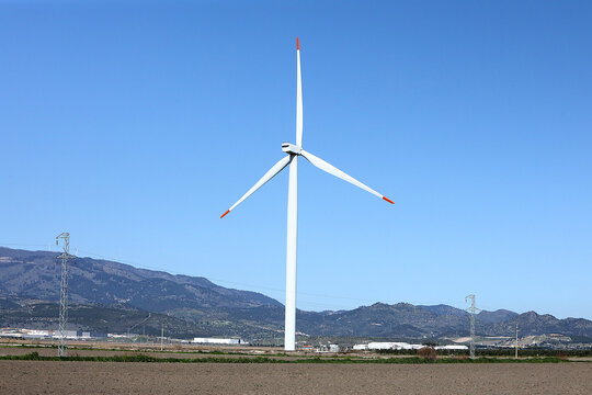 A wind turbine is a device that converts the kinetic energy of wind into electrical energy.