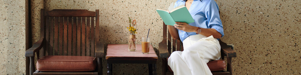 Web banner with woman enjoying iced coffee and good book