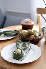 Festive Easter table setting with Easter bunny made of linen napkin and egg