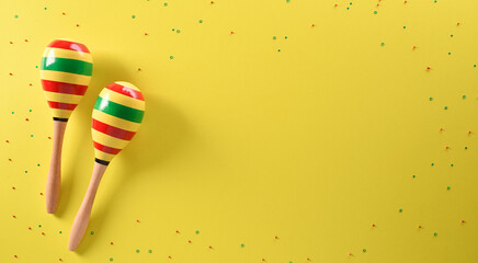 Cinco de Mayo holiday background made from maracas stars on yellow background.
