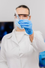 A scientist in a modern laboratory studies samples and conducts experiments. Microbiology, pharmaceutical biochemistry, medical technology. Working on vaccines and medicines in a team of specialists.
