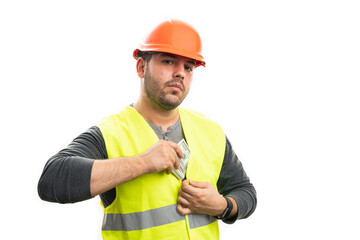 Serious  male builder hiding cash money inside fluorescent vest
