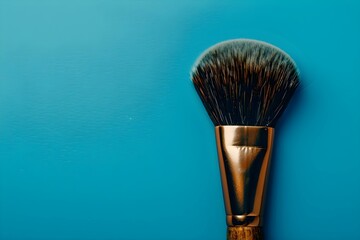 Professional centered photo of a makeup brush on a blue background with copy space. Concept Beauty Photography, Product Showcase, Bold Colors, Professional Composition, Copy Space - obrazy, fototapety, plakaty