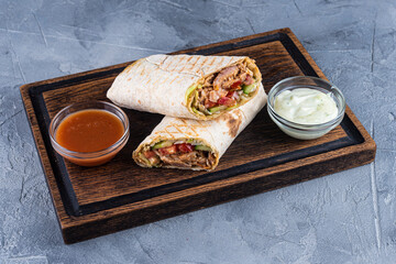 Traditional shawarma with sauce on gray background