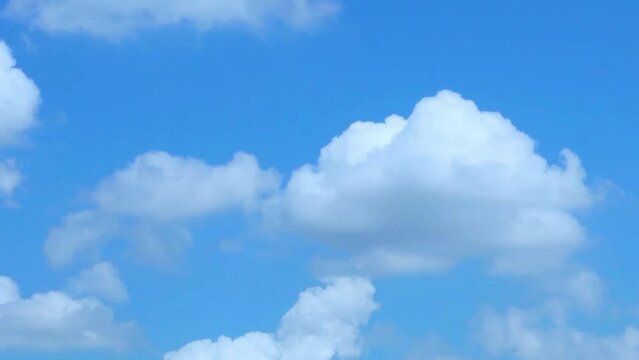 Beautiful Puffy White Clouds Slide on Pure Blue Sunny Sky. Layer of White Cumulus Clouds in Clear Blue Sky Moving Horizontal Time lapse. Blue Sky and White Fluffy Clouds, Blue Skyscraper.