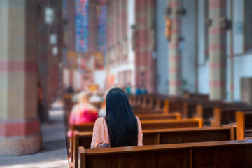 Blurred photo inside of a church - People praying in a church