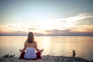 Deurstickers Woman meditating at the sea © nickolya