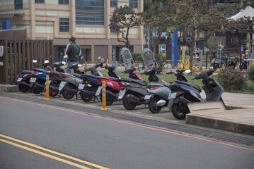 Obraz premium motorcycle on the street taiwan taipei asia travel road transport micro mobility cycle bike scooter motor gas speed city urban motion riding ride traffic motorbike