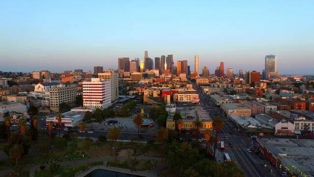 Aerial Panning Shot Of Modern Downtown District Against Clear Sky In City During Sunset - Los Angeles, California