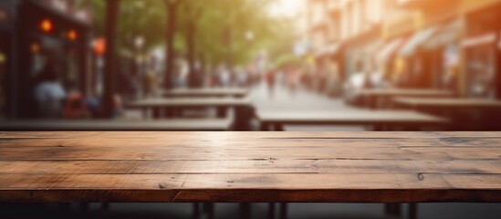 An image of a wooden table top featuring a blurred city street in the background