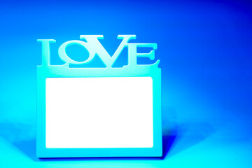 White frame with the inscription love on a blue background.
