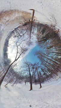 Embark on a captivating journey through a serene winter forest in this 360-degree video. The immersive footage transports you to a tranquil snow-covered landscape, where you ll feel like youre walking