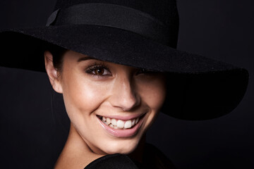 Fashion, hat and woman with smile in portrait, dark aesthetic with mockup space and style on black...