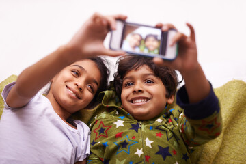 Phone screen, selfie and kid siblings on a floor for fun, vacation or memory at home from above....