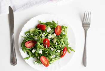 Green vegan salad with arugula leaves and cherry tomatoes. Snack, food