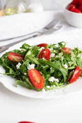 Green vegan salad with arugula leaves and cherry tomatoes. Snack, food