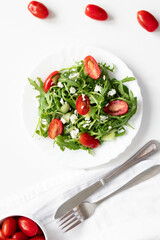 Green vegan salad with arugula leaves and cherry tomatoes. Snack, food