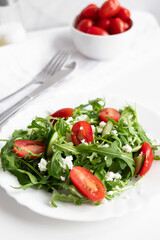 Green vegan salad with arugula leaves and cherry tomatoes. Snack, food