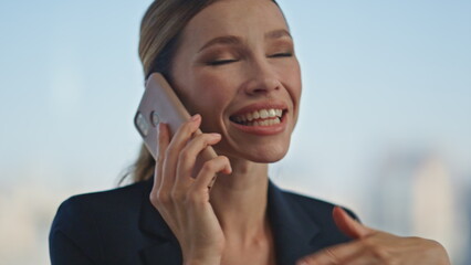 Happy worker gossiping cell in office closeup. Attractive boss woman speaking